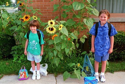 Sarah and Emily with sunflowers in the background on the first day of school -- Aug. 25,1999!